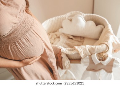 Pregnant woman waiting for a baby in the nursery near the cradle. - Powered by Shutterstock