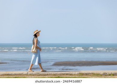 Pregnant woman walk along at the seaside - Powered by Shutterstock