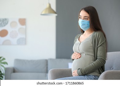 Pregnant Woman Wearing Medical Mask At Home