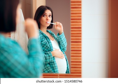 Pregnant Woman Wearing Pajamas Brushing her Teeth. Mother to be being careful with oral hygiene during pregnancy
