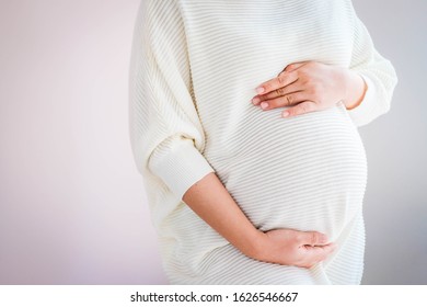 Pregnant woman in white cloth. Young woman expecting a baby. - Shutterstock ID 1626546667