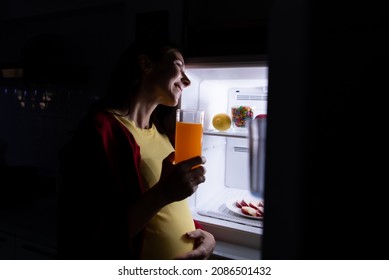 A Pregnant Woman Who Wakes Up Late At Night Looking For Food In The Refrigerator Because Of Hunger.