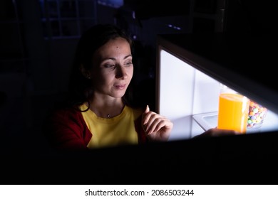 A Pregnant Woman Who Wakes Up Late At Night Looking For Food In The Refrigerator Because Of Hunger.