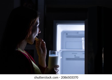 A Pregnant Woman Who Wakes Up Late At Night Looking For Food In The Refrigerator Because Of Hunger.