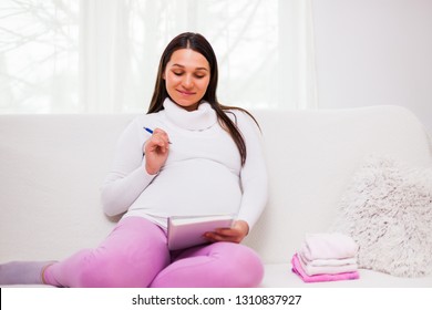 Pregnant Woman Writing To Do List.