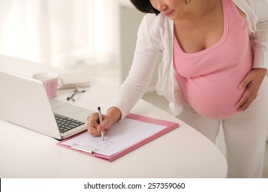 Pregnant Woman Writing To Do List