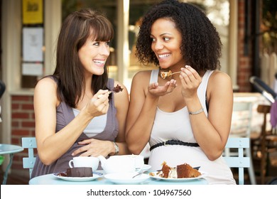 Pregnant women sitting outside cafÃ?Â© - Powered by Shutterstock