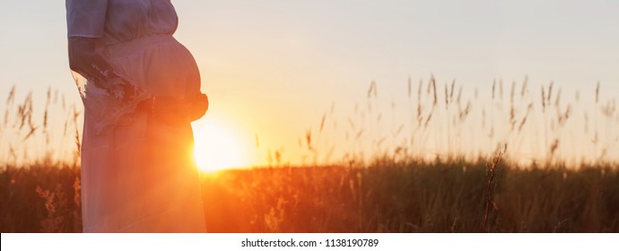pregnant women at sunset