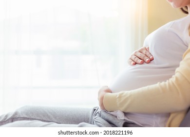 Pregnant Young Asian Mom Touching Belly With Love On Bed Mom Get Happiness Young Asia Mother Love Her Baby So Much Mom Waiting And Expecting Baby Has Good Health Pregnancy And Health Care Concept