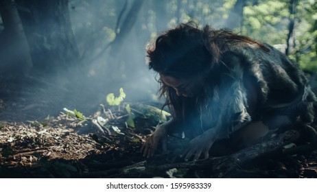 Prehistoric Cave Woman Hunter-Gatherer Searches for Nuts and Berries in the Forest. Primitive Neanderthal Woman Finding Food in the Sunny Forest