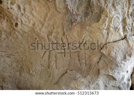 Prehistoric rock carving (petroglyph) in Gobustan, Azerbaijan, depicting human figure riding a horse.