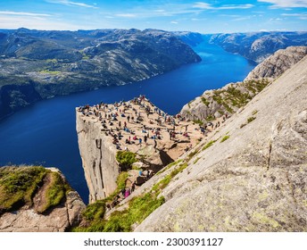 Preikestolen or Prekestolen or Pulpit Rock is a famous tourist attraction near Stavanger, Norway. Preikestolen is a steep cliff which rises above the Lysefjord. - Powered by Shutterstock