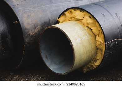 Pre-insulated pipe. Steel pipe with an upper layer of polyurethane foam insulation. Thermal insulation. Modern pipeline for supplying hot water and heating to a residential area. Industrial concept
