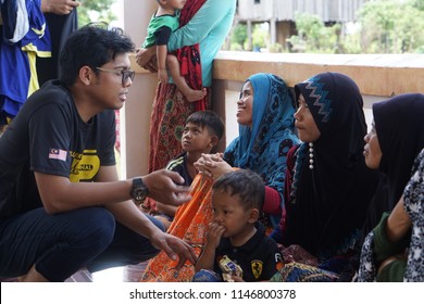 Prek Sandai, Cambodia - July 12 2018: A Malaysian Volunteer From The Kinabalu Residential College, University Of Malaya Talking To Local Cambodian People. They Are In A Mosque.