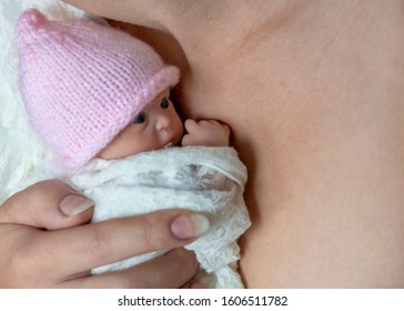 premature newborn baby wrapped in lace blanket  represented by a reborn doll; background for copy space and text overlay
