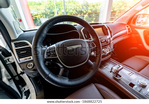 Premium car interior. Brown leather seat in\
luxury auto. Closeup.