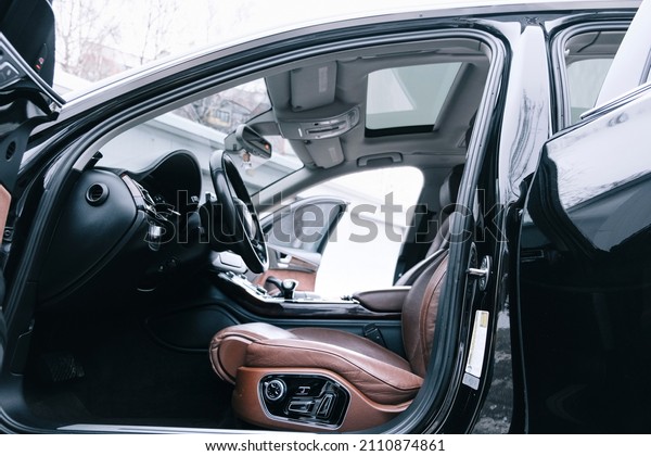 Premium car interior, brown perforated leather,\
decorative inserts the  interior, painted in orange wood color,\
leather steering wheel.