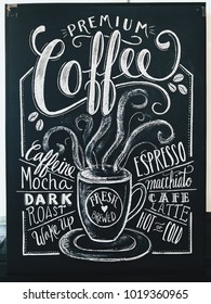 Premium coffee sign drawn in white chalk on a black chalkboard. Used in cafe, bistro, and restaurant.