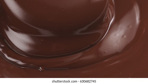 Premium Dark Melted Chocolate Being Poured From Spoon In Left Part Of Frame From Above Toned, 4k Photo