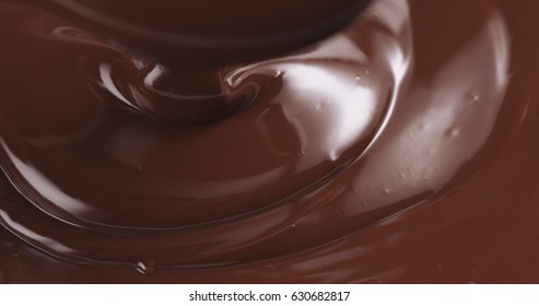 Premium Dark Melted Chocolate Being Poured From Spoon In Left Part Of Frame From Above Toned, 4k Photo