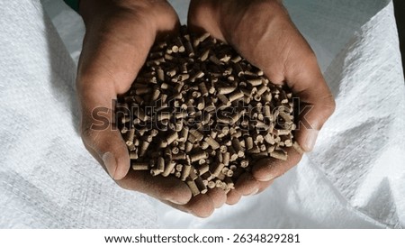 Premium Fish Feed Pellets in Hands – Aquaculture Nutrition