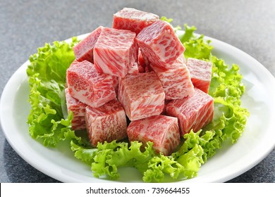 Premium Japanese wagyu diced beef cubes sliced on plate for yakiniku