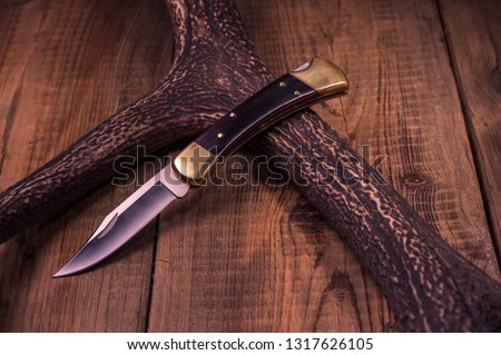 Premium knife. Legendary hunting knife. Hunting knife and antler. Front view.