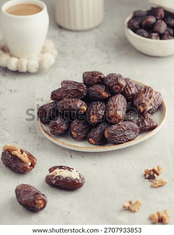 Premium Medjool dates in a rustic table setting with a cup of coffee and soft background. Warm tones and layered composition ideal for cultural food branding, Ramadan visuals, and recipe blogs.