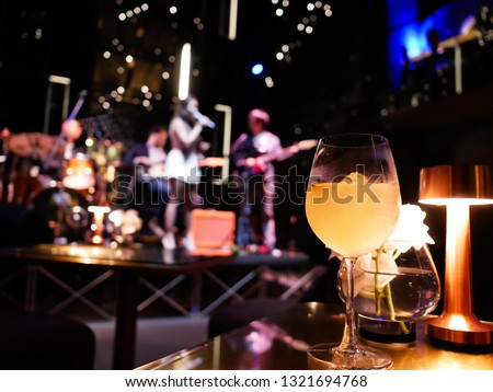 Premium mocktail in restaurant with blurred music band as background 