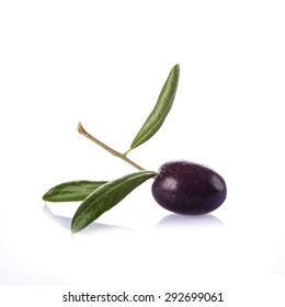 Premium raw olive with its leaves and branch on a white background - Shutterstock ID 292699061