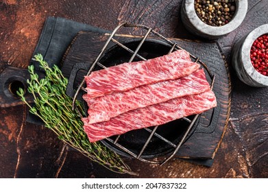 Premium Raw Sliced Wagyu Beef A5 Steaks On A Grill For Yakiniku. Japanese Foods. Dark Background. Top View