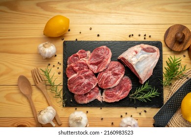 Premium Shank beef in black stone plate on wooden background.Fresh Silver shank meat in black plate on wooden background. - Powered by Shutterstock