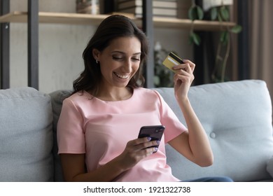 Premium status. Successful young arab female vip bank client enjoy shopping pay online using cell. Satisfied indian lady important customer get exclusive bonus discount using gold card for web payment