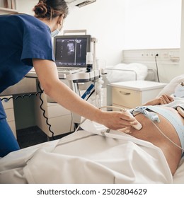 Prenatal medical exam. Female doctor using ultrasound scanner for gynecologist telling and showing patient embryo. Fertility pregnancy ovulation concept. - Powered by Shutterstock