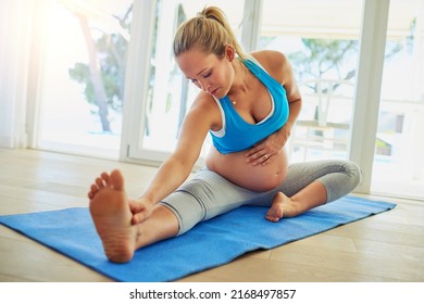Prenatal pilates. Shot of a pregnant woman working out on an exercise mat at home.