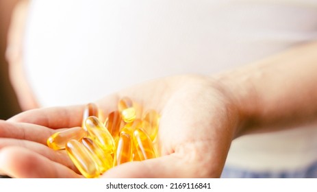 Prenatal Vitamins Pill. Happy Smiling Woman Taking Pill With Supplement Vitamin Omega 3. Vitamin D, E, A Fish Oil Capsules