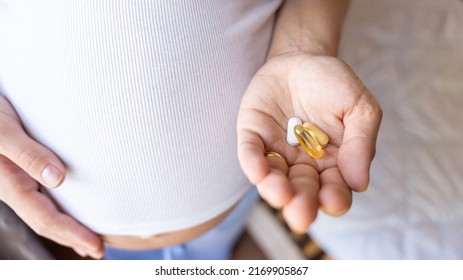 Prenatal Vitamins Pill. Happy Smiling Woman Taking Pill With Supplement Vitamin Omega 3. Vitamin D, E, A Fish Oil Capsules