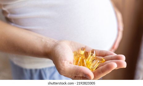 Prenatal Vitamins Pill. Happy Smiling Woman Taking Pill With Supplement Vitamin Omega 3. Vitamin D, E, A Fish Oil Capsules