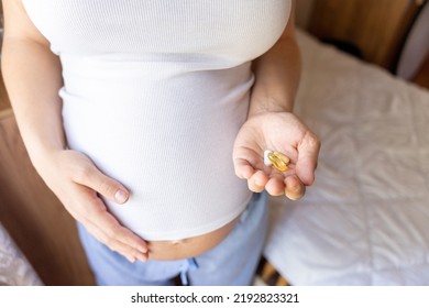 Prenatal Vitamins Pill. Happy Smiling Woman Taking Pill With Supplement Vitamin Omega 3. Vitamin D, E, A Fish Oil Capsules