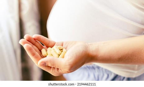 Prenatal Vitamins Pill. Happy Smiling Woman Taking Pill With Supplement Vitamin Omega 3. Vitamin D, E, A Fish Oil Capsules