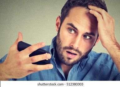 Preoccupied Shocked Man Feeling Head, Surprised He Is Losing Hair, Receding Hairline, Bad News Isolated On Gray Background. Negative Facial Expressions, Emotion