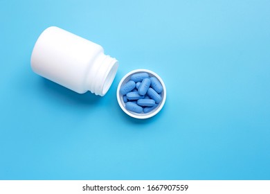 PrEP ( Pre-Exposure Prophylaxis) Used To Prevent HIV, In Plastic Pill Bottle Cap On Blue Background, Copy Space