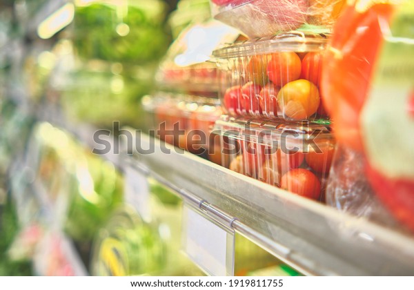 Prepackaged salads in a commercial refrigerator,\
salad ready to eat. Concept of healthy food, bio, vegetarian, diet.\
Selective focus.