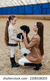 Prepairing For Horse Riding. Cute Girl In Jockey Cap.