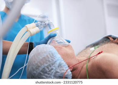 Preparation for anesthesia and surgical intervention of an elderly man. An elderly man is undergoing surgery. Modern medicine. - Shutterstock ID 2331120775