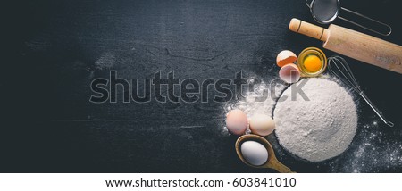 Preparation for baking. Eggs with a rolling pin. On the stone table. Free space for text . Top view.