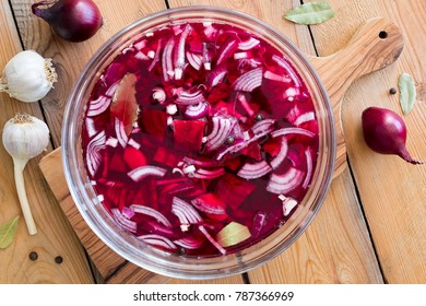 Preparation of beet kvass (fermented red beets) - beets, onions, garlic, bay leaf and allspice in a bowl