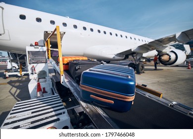 Preparation before flight. Loading of luggage to airplane at airport. 