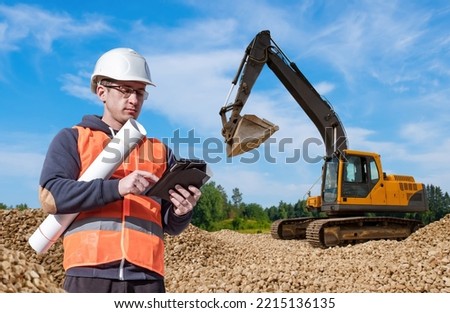 Preparation for construction. Man with tablet. Excavator driver away from machine. Man excavator driver. Concept site preparation for construction. Excavator driver inspecting construction site