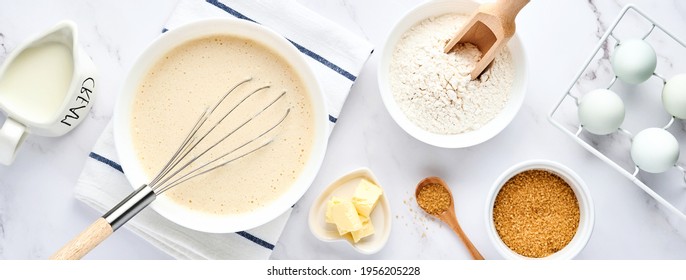 Preparation of dough for home pancakes for Breakfast or for Maslenitsa. Ingredients on the table - wheat flour, eggs, butter, sugar, salt, milk. Recipe step by step. Top view. - Powered by Shutterstock
